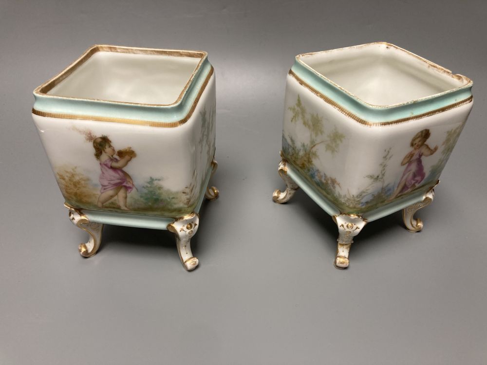 A set of three 19th century French porcelain jardinieres, painted with classical children playing, tallest 14.5cm width 22cm